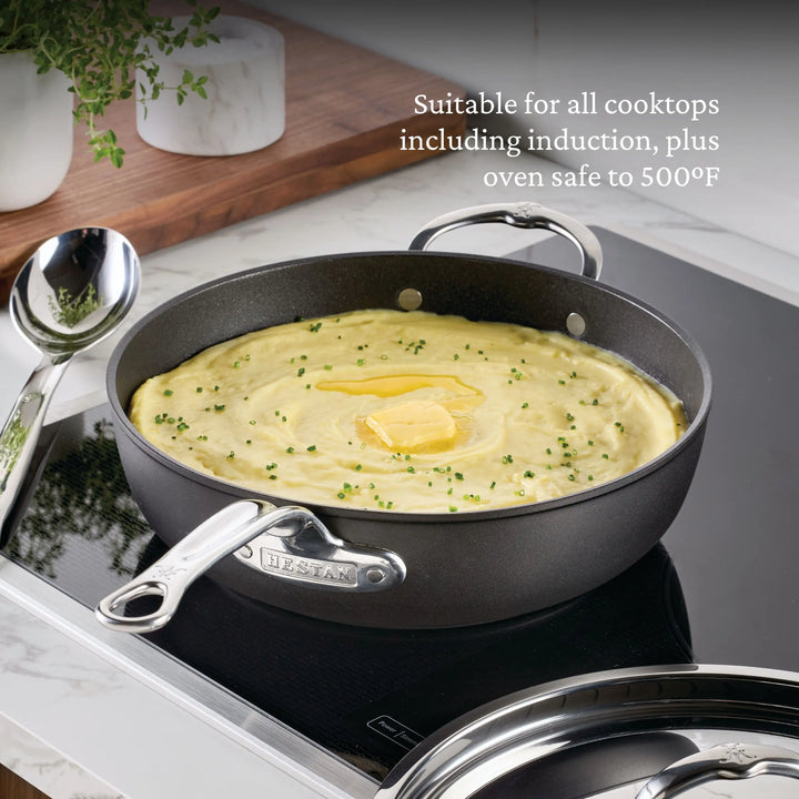 The TITUM® Fusion TITUM Nonstick Cookware Set, 10-Piece, handcrafted in Italy and induction compatible, sits on an induction cooktop with mashed potatoes. Text highlights its nonstick surface and oven safety up to 500°F.
