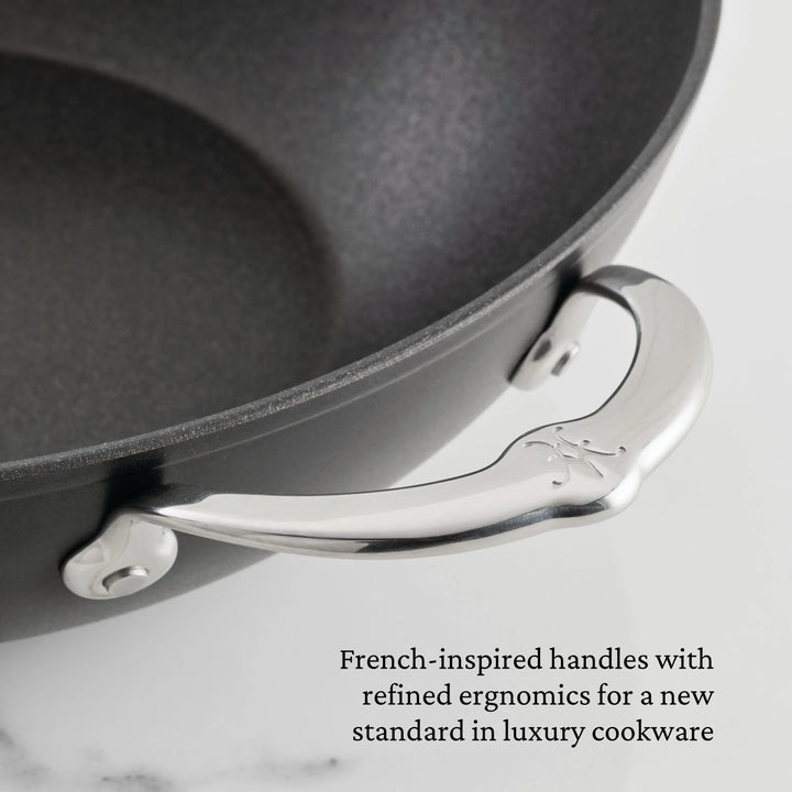 Close-up of the TITUM® Fusion TITUM Nonstick Essential Pan with Lid, 4.5-Quart, featuring a polished French-inspired metal handle engraved with a decorative pattern and refined ergonomic design for luxury nonstick cookware.