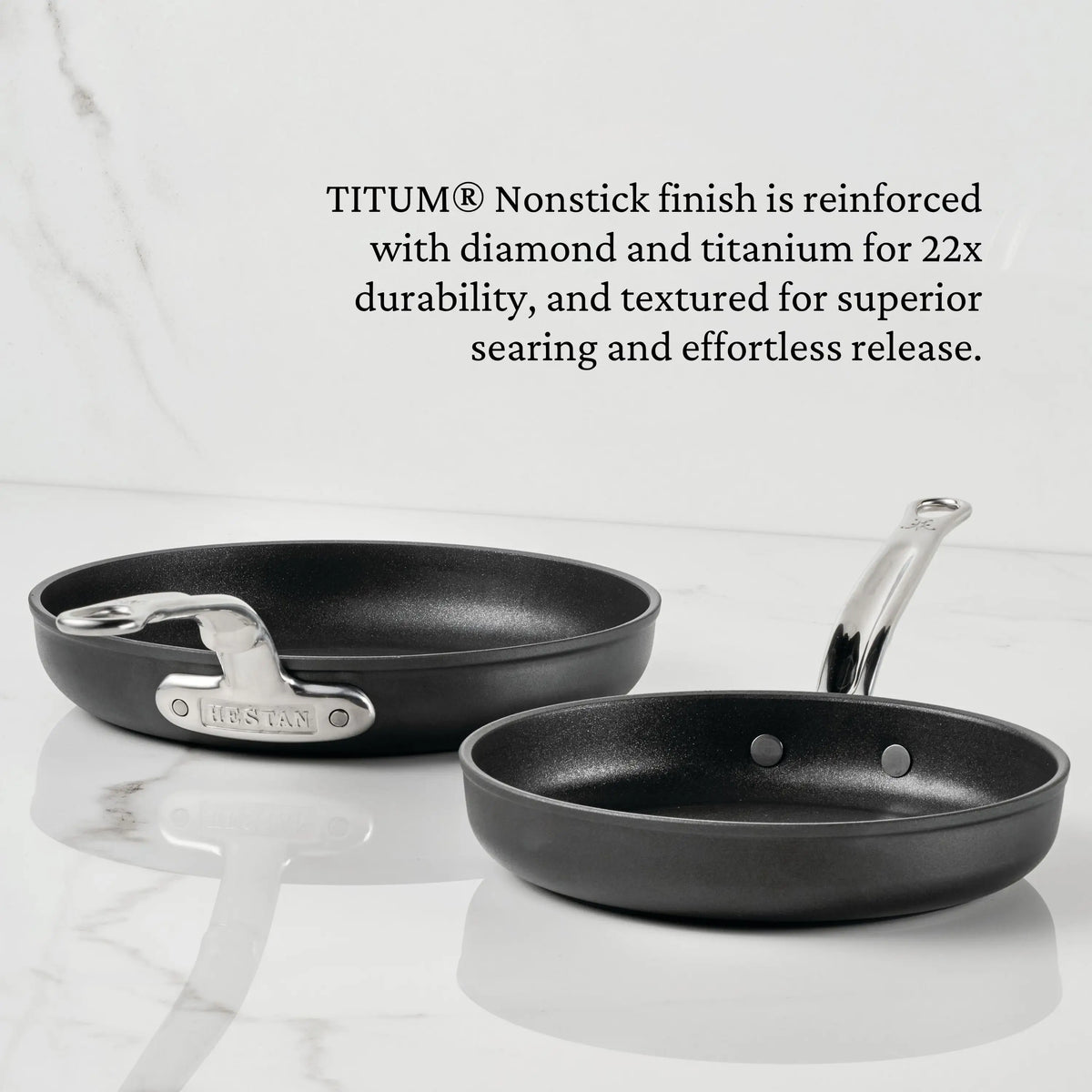 Two TITUM® Fusion 11-Inch Nonstick Skillet pans with silver handles are displayed on white marble—one upright, one upside down to show the handle and base. Feature details for the TITUM Nonstick Skillet with Lid appear above.