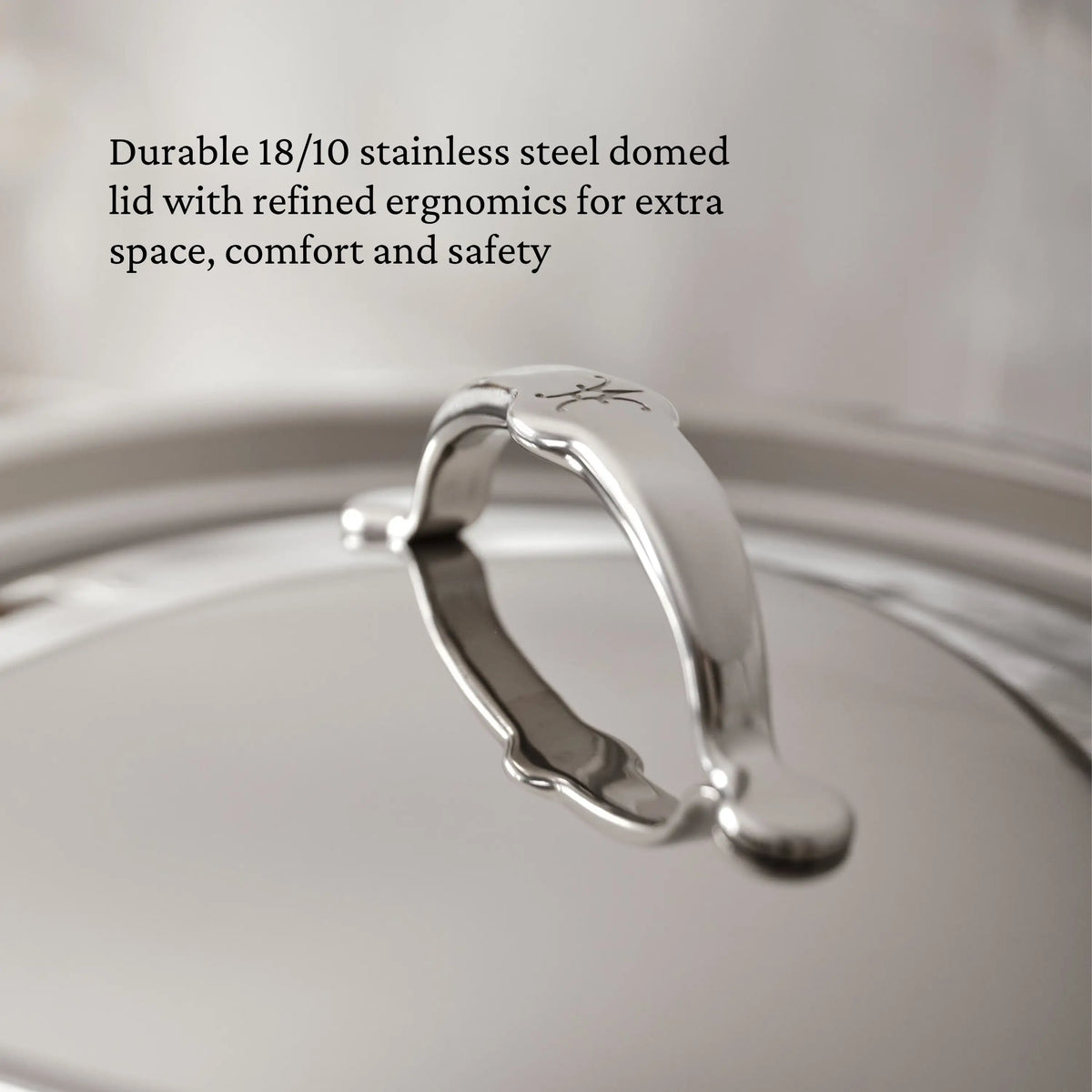 Close-up of TITUM® Fusion 12.5-Inch Nonstick Wok’s domed stainless steel lid with curved handle, showcasing its smooth, reflective surface. Durable and ergonomic, it offers extra space for comfort and safety in premium nonstick cookware.