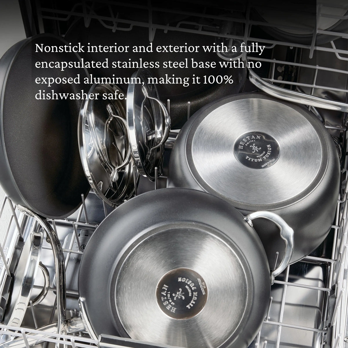 The TITUM® Fusion TITUM Nonstick Wok with Stick Handle and Dome Lid, 12.5-Inch, sits in the dishwasher’s bottom rack. Text highlights its nonstick surface, encapsulated base, and dishwasher-safe design.