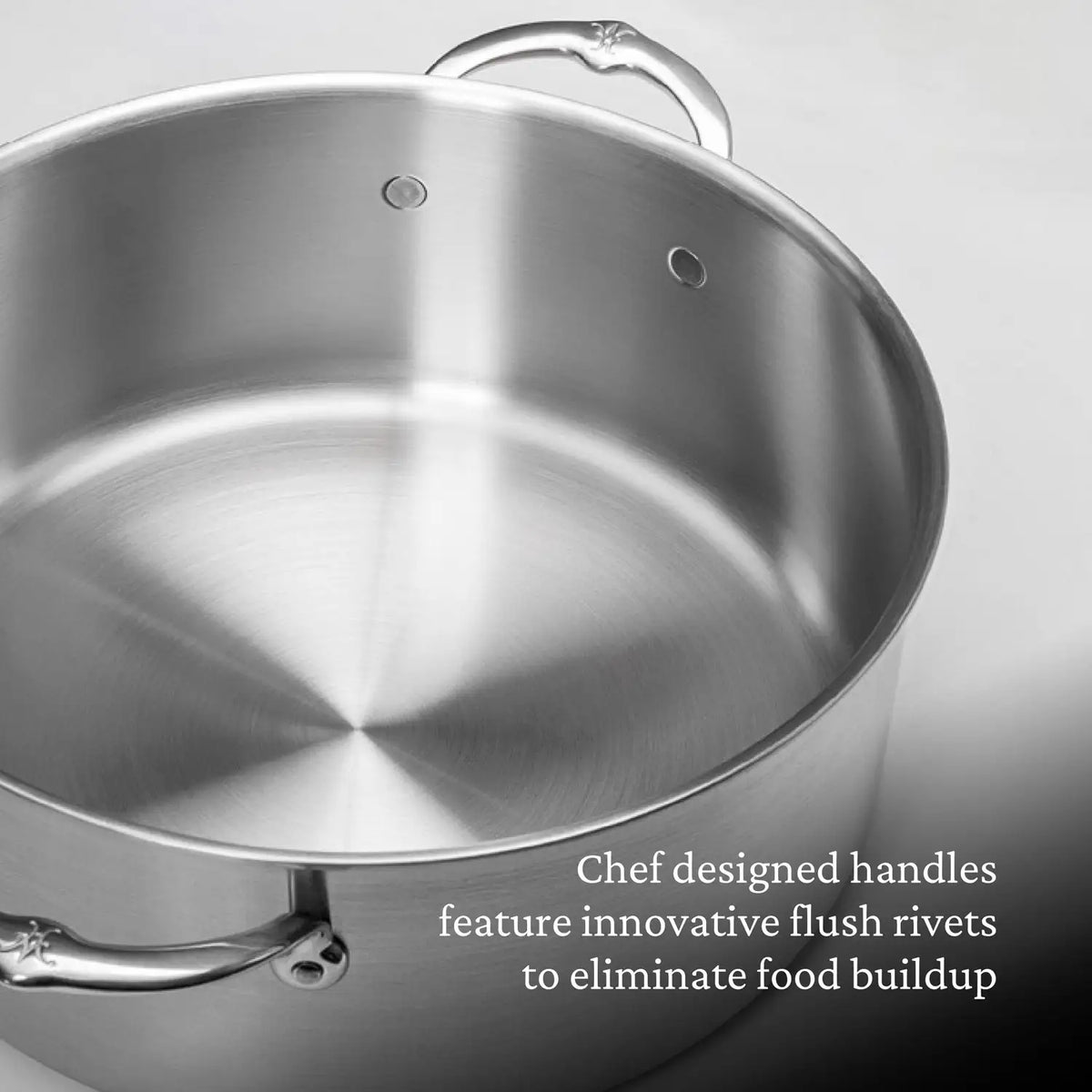 Close-up of the Thomas Keller Commercial Clad Stainless Steel Rondeaus, featuring tri-ply construction, chef-designed handles, and flush rivets to prevent food buildup—crafted in collaboration with Chef Thomas Keller.