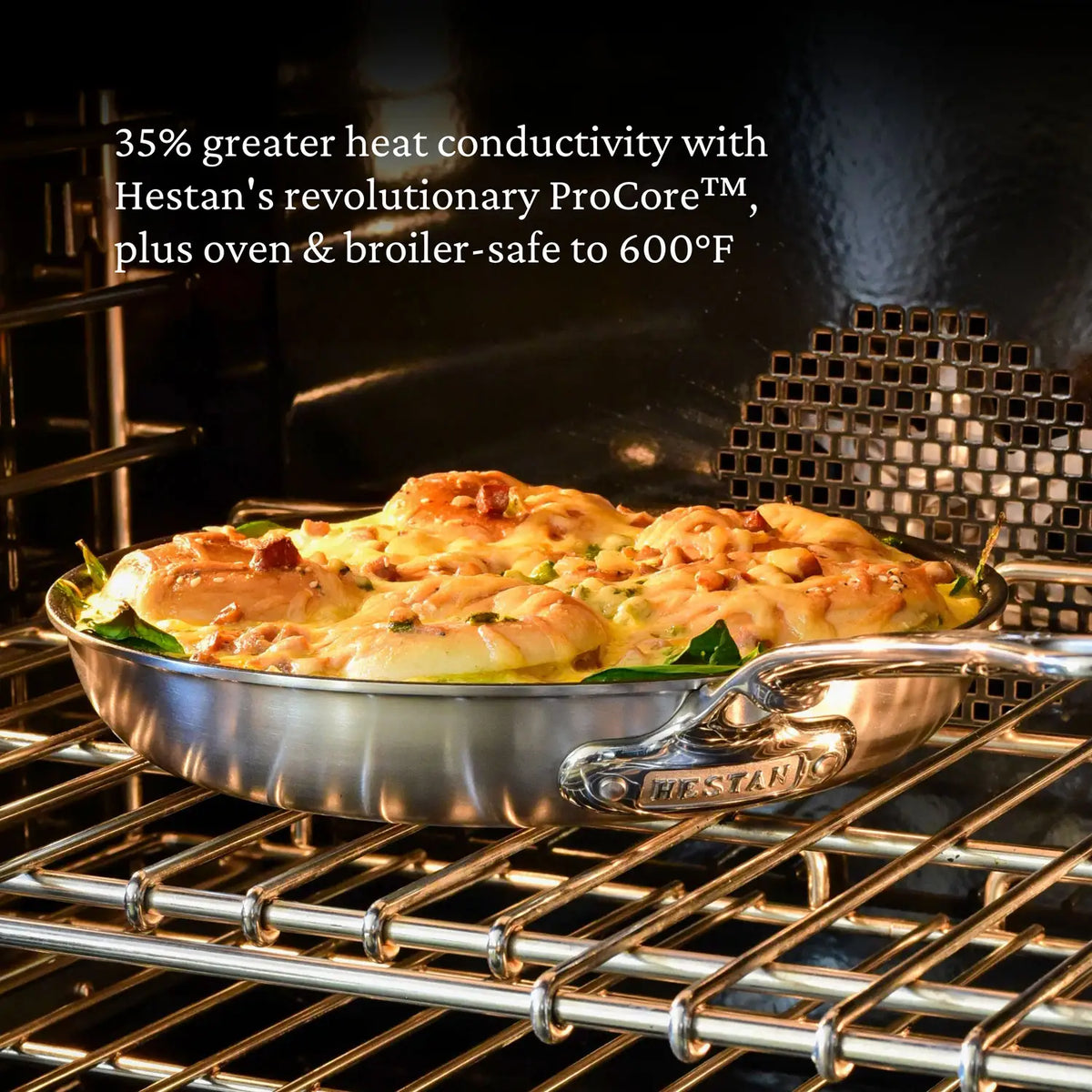 A Thomas Keller Commercial Clad Stainless Steel Skillet filled with baked food sits on an oven rack, with text above highlighting its professional heat conductivity and safe use in the oven or broiler up to 600°F.
