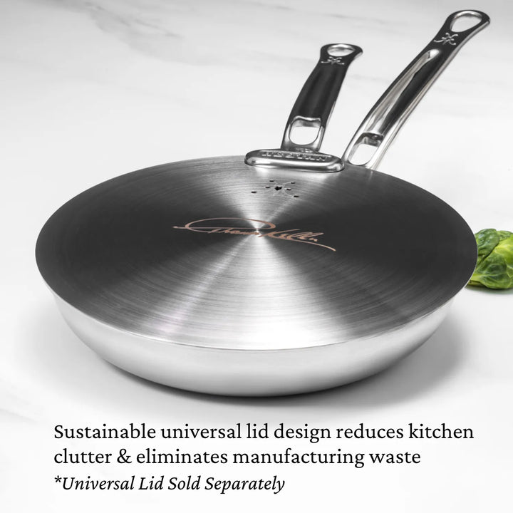 Image shows the Thomas Keller Commercial Clad saute pan covered by a Universal Lid. Text on image reads: "Sustainable, chef-designed lids reduce manufacturing waste and kitchen clutter." Universal lids are compatible with all Hestan cookware and are sold separately.