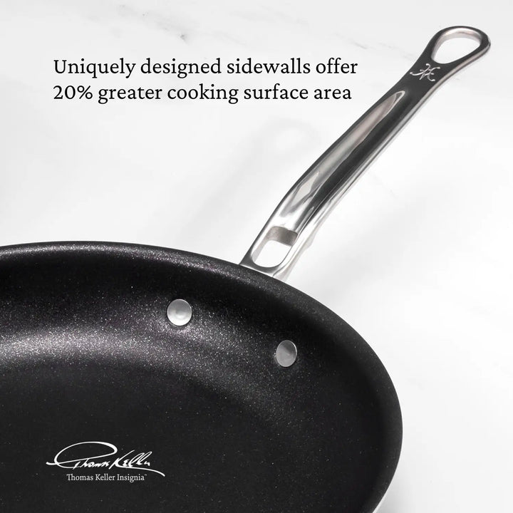 This image show the TITUM nonstick skillet at an angle that showcases the dimension and shape of the interior pan. Text on image read: "Uniquely designed sidewalls offer 20% greater cooking surface area". This is compared to pan of a similar style and size.