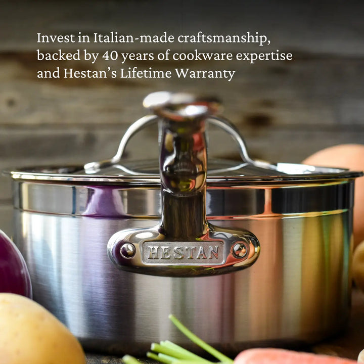 A ProBond Professional Clad stainless steel pot from the 10-piece Ultimate Set, engraved on the handle, is surrounded by fresh vegetables like a potato and an onion. The text highlights Italian craftsmanship, a tri-ply body, 40 years of expertise, and a lifetime warranty.