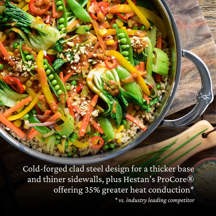 A vibrant stir-fry with snap peas, bell peppers, carrots, and bok choy over rice sizzles in a 3.5-quart ProBond Professional Clad Stainless Steel Braiser with Lid, boasting 35% greater heat conduction than competitors.