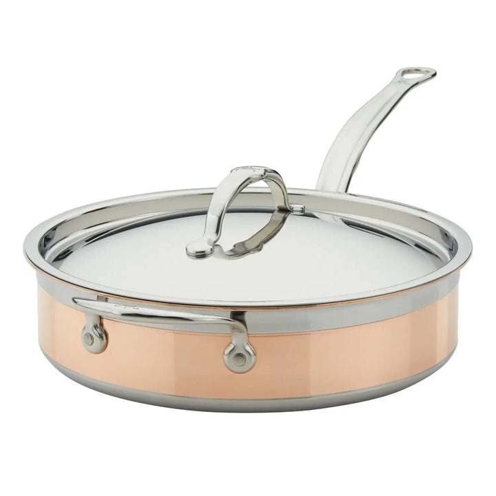 The CopperBond Copper Induction Sauté with Lid, 3.5-Quart features a copper core and stainless steel construction for even heat distribution. It has a shiny finish, dual looped rivets, an induction-compatible design, and the lid includes a matching handle for added elegance.