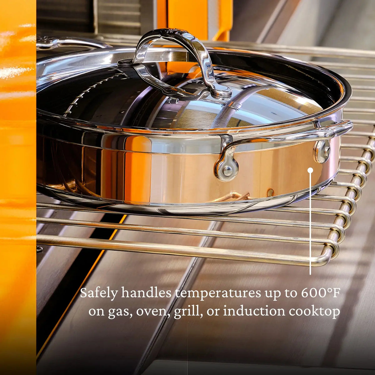 The CopperBond Copper Induction Braiser with Lid, 3.5-Quart, featuring a copper core, sits on the oven rack and can handle temperatures up to 600°F on gas, oven, grill, or induction cooktop.