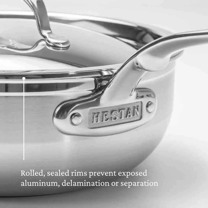 Close-up of a shiny ProBond Professional Clad stainless steel TITUM® nonstick essential pan, 3.5-quart. Focus on the handle with the embossed brand name. Text reads: Rolled, sealed rims prevent exposed aluminum, delamination or separation. Ideal for any kitchen with enduring performance.