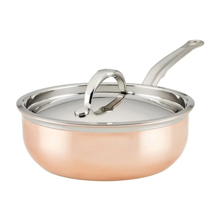 The CopperBond Copper Induction Saucier Pan, 2-Quart, features a polished finish and rounded edges. It has a stainless steel handle and slightly domed lid that fits snugly on the pan, making it ideal for induction cooking.