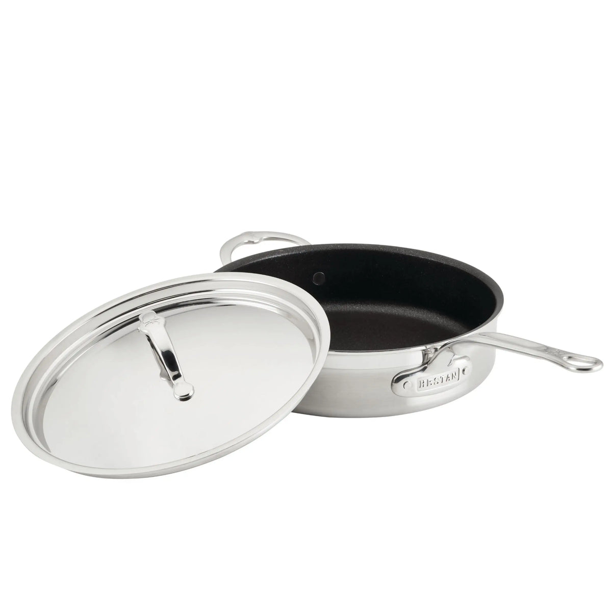 A ProBond Professional Clad Stainless Steel TITUM® Nonstick Sauté Pan, 3.5-quart, sits on a white surface with its long handle and smaller support handle visible. Its matching lid is partially covering the pan.