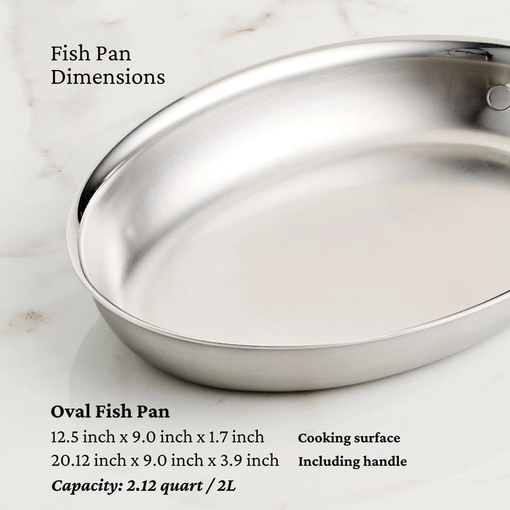 A stainless steel oval fish pan from the Thomas Keller Insignia Commercial Clad Stainless Steel 29-Piece Cookware Set sits on marble, with text showing its dimensions and 2.12 quart/2L capacity—perfect for any stainless steel kitchen collection.