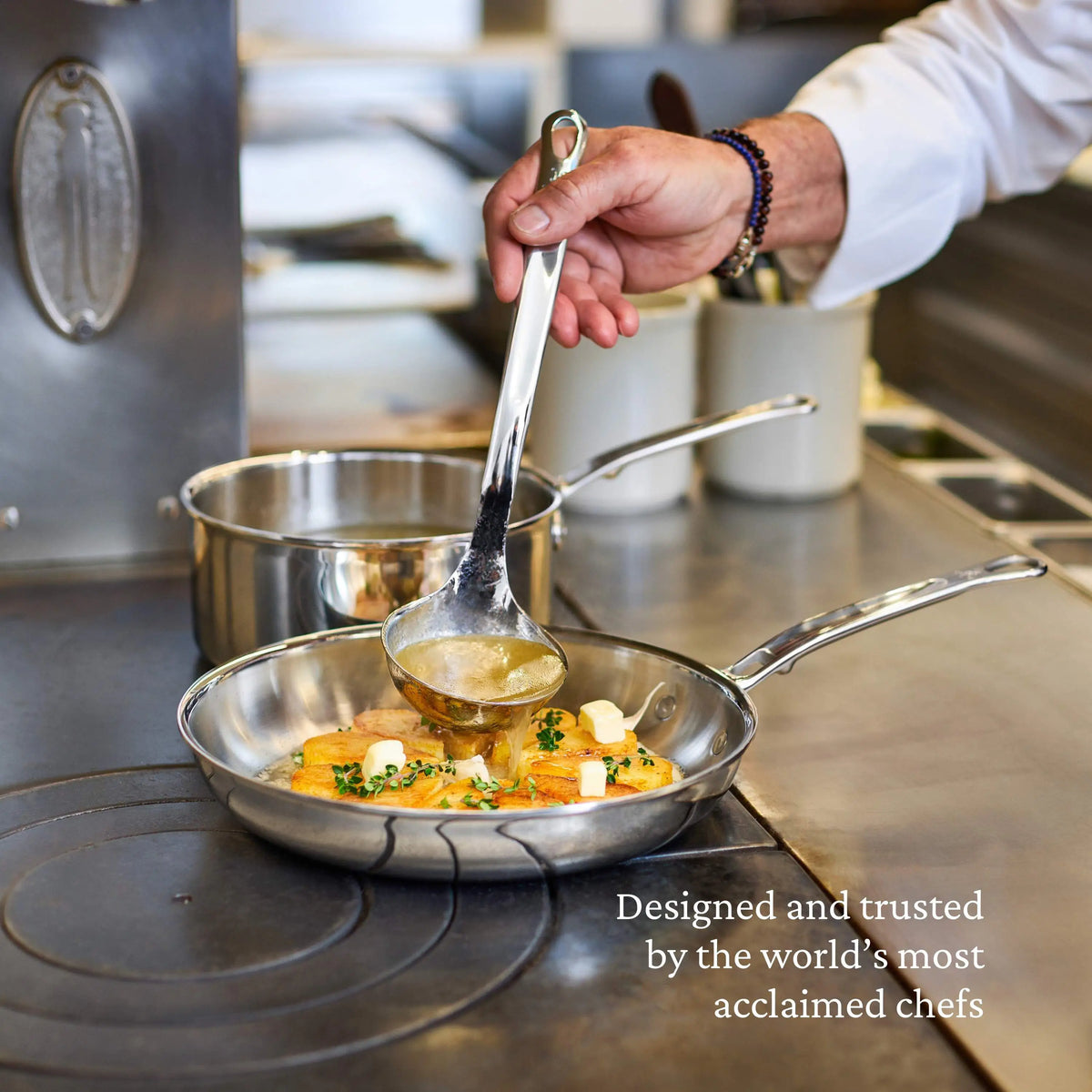 A chef pours sauce onto a dish in a stainless steel pan from the ProBond® Luxe™ Polished Clad Stainless Steel Ultimate Set, 10-Piece. Text: “Designed and trusted by top chefs for superior Italian craftsmanship.”.