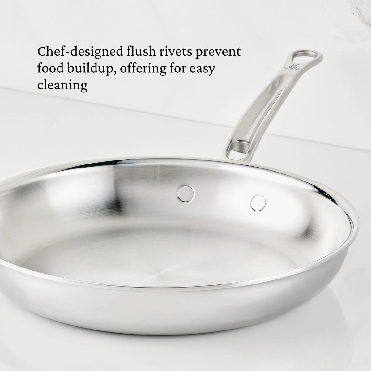 A ProBond® Luxe™ Polished Clad Stainless Steel Skillet with flush interior rivets and a metal handle is shown on a white background. Text highlights the easy-cleaning benefit of this premium stainless steel cookware.