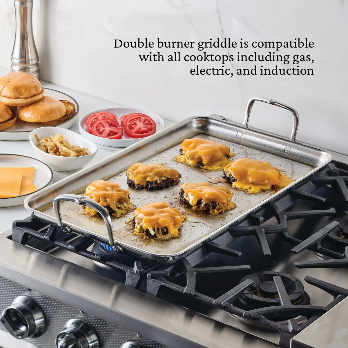 A NanoBond Titanium x Tyler Florence 41-piece cookware set double burner griddle cooks six cheeseburgers on a gas stove, while plates with buns, tomato slices, grilled onions, and cheese wait nearby. Cooktop compatibility details are displayed.