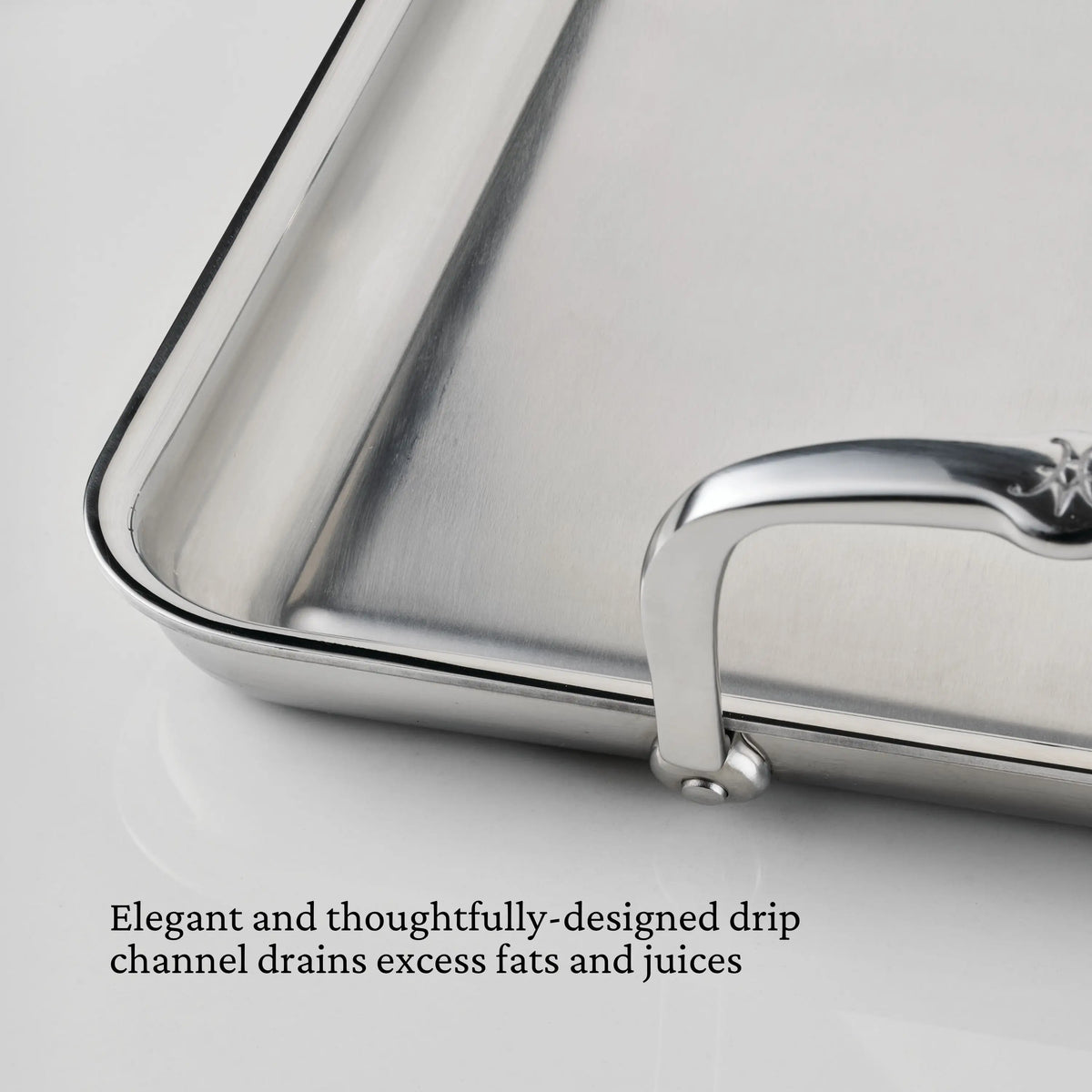 Close-up of the Hestan Provisions Double Burner Griddle, 21x13, featuring a handle and a drip channel along the edge—an essential addition to your stainless steel cookware for easy draining of fats and juices.