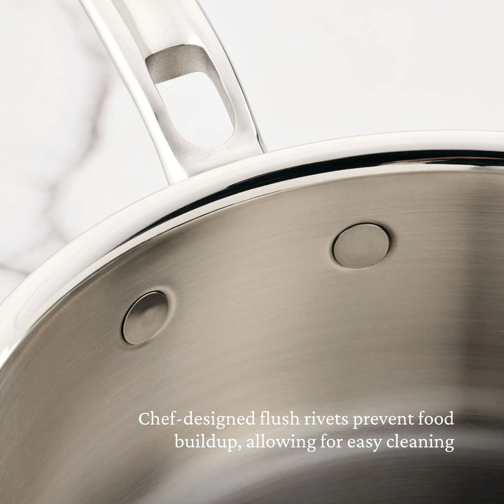 Close-up of the Polished Clad Stainless Steel Saucier Pan, 2-Quart by ProBond® Luxe™, highlighting two flush rivets inside that help prevent food buildup and make cleaning easier.
