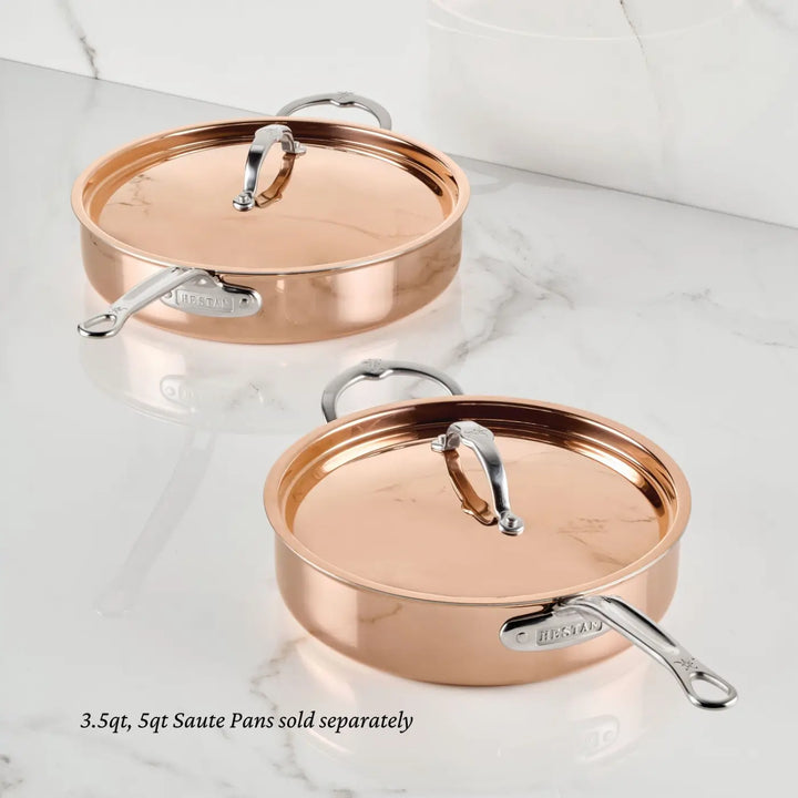 Two Polished Copper Saute Pans with Lids by CopperBond® Aura™ rest on a white marble countertop. Each pan features shiny metal handles, a durable stainless steel interior, and is branded with the CopperBond® Aura™ name. Text below reads: 3.5qt, 5qt Polished Copper Saute Pans sold separately.