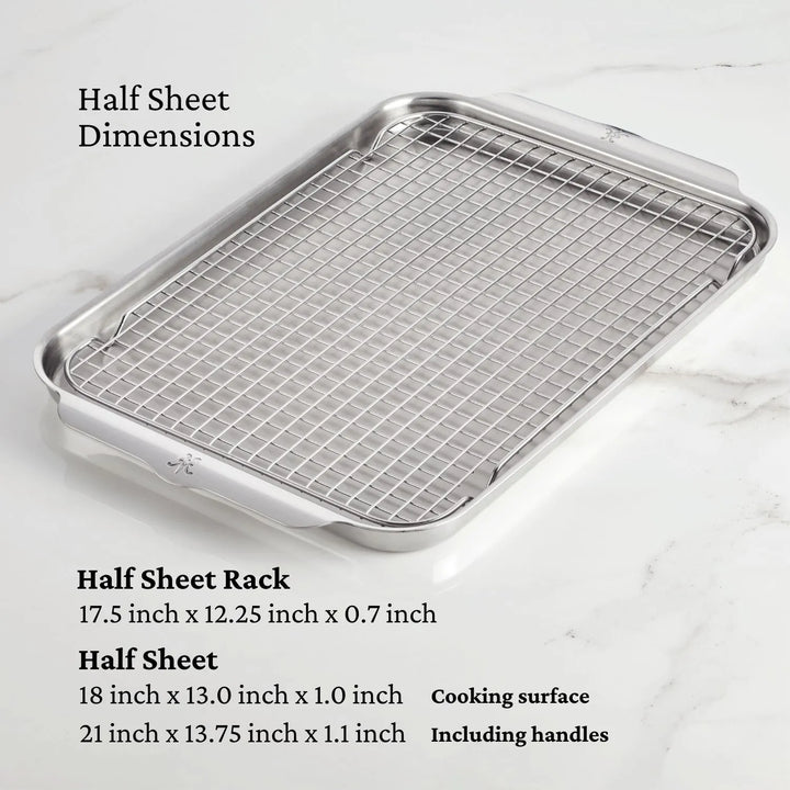 The OvenBond Tri-ply 3-Piece Set by Hestan Provisions features a warp-resistant stainless steel roasting sheet with grid rack, shown on a marble surface. Rack measures 17.5x12.25x0.7, and the sheet is 18x13x1 for cooking area, expanding to 21x13.75x1.1 with handles included.