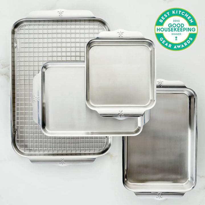 The award-winning Hestan Provisions OvenBond Tri-ply 5-Piece Set includes four durable stainless steel baking trays—one square, three rectangular—and a wire rack. A Good Housekeeping Best Kitchen Gear Awards 2023 badge is in the upper right corner.