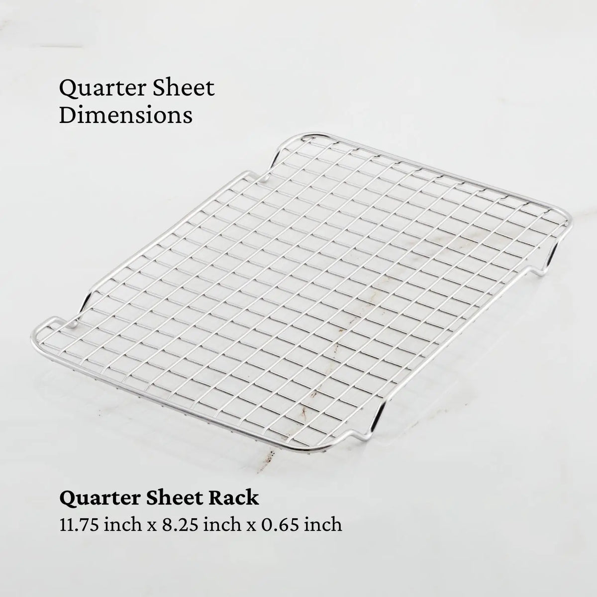 The image shows an OvenBond Stainless Steel Quarter Sheet Pan Rack from Hestan Provisions. It has a sturdy metal design with grid wires, raised edges, and dimensions written as 11.75 x 8.25 x 0.65, ideal for use with the corresponding quarter sheet pan.