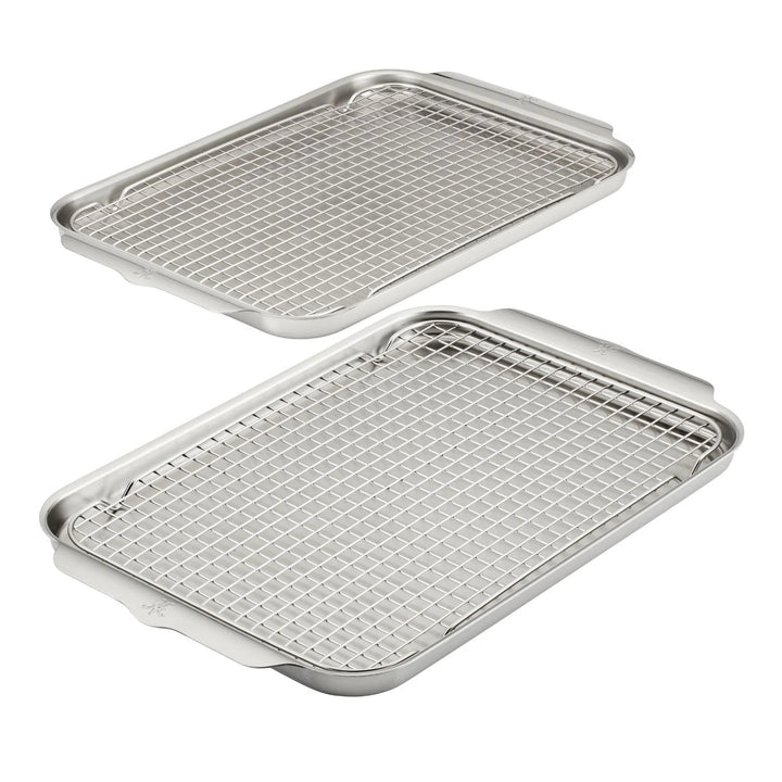 Two Hestan Provisions OvenBond Tri-ply sheets, each with a raised edge and a grid rack, are creatively displayed on a pristine white background.