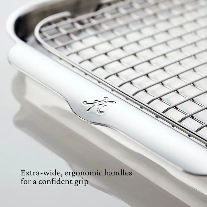 A close-up of a metal cooling rack reveals extra-wide stainless steel handles with an engraved design for a secure grip. Perfectly complements your Hestan Provisions OvenBond Tri-ply 4-Piece Set for seamless kitchen experiences.