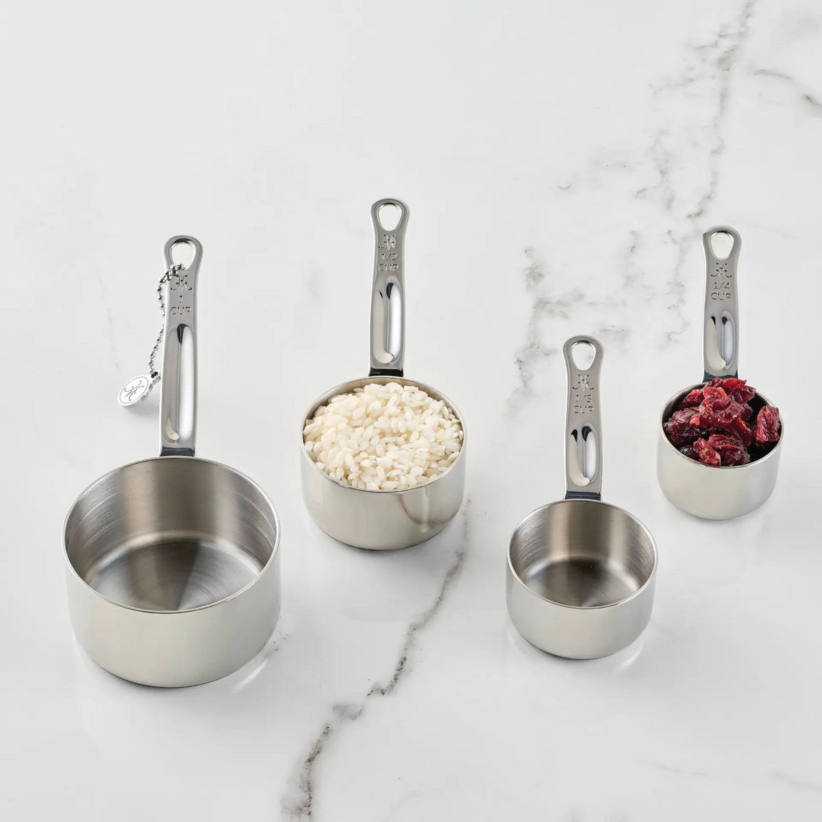 Four Hestan Provisions measuring cups for kitchen use