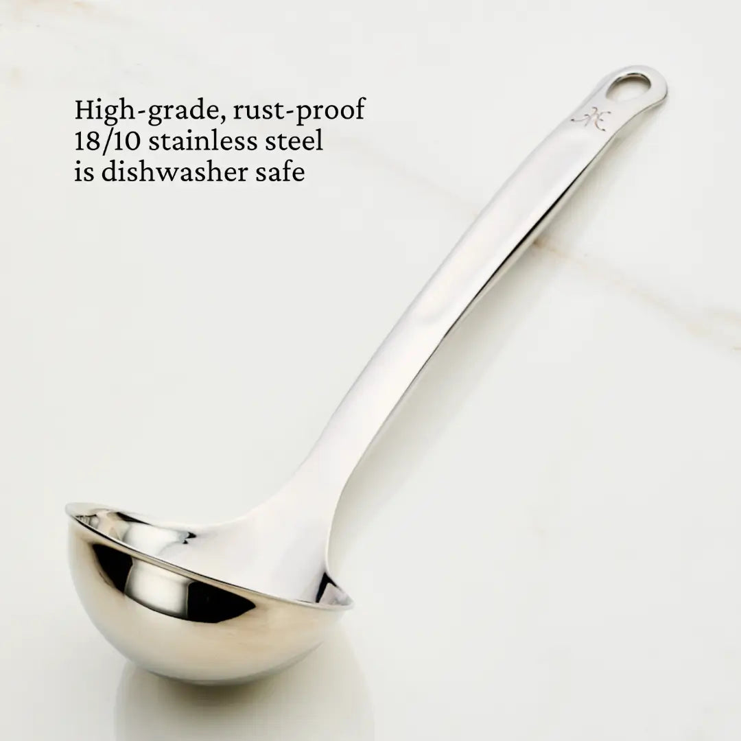The Hestan Provisions 5-ounce Ladle, made of high-grade, rust-proof 18/10 stainless steel, features a smooth finish with a hole at the handles end. Its displayed on a white surface and is dishwasher safe.
