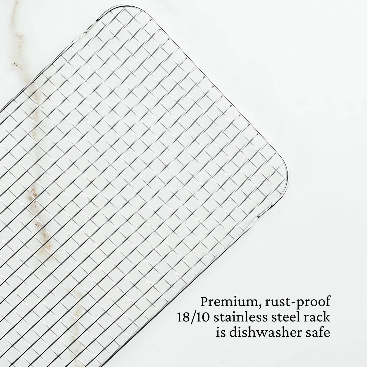 The Hestan Provisions OvenBond Stainless Steel Medium Pan Rack with a grid pattern is on the left side of a light background. Text in the lower right corner reads: Premium, rust-proof 18/10 stainless steel roasting rack is dishwasher safe.