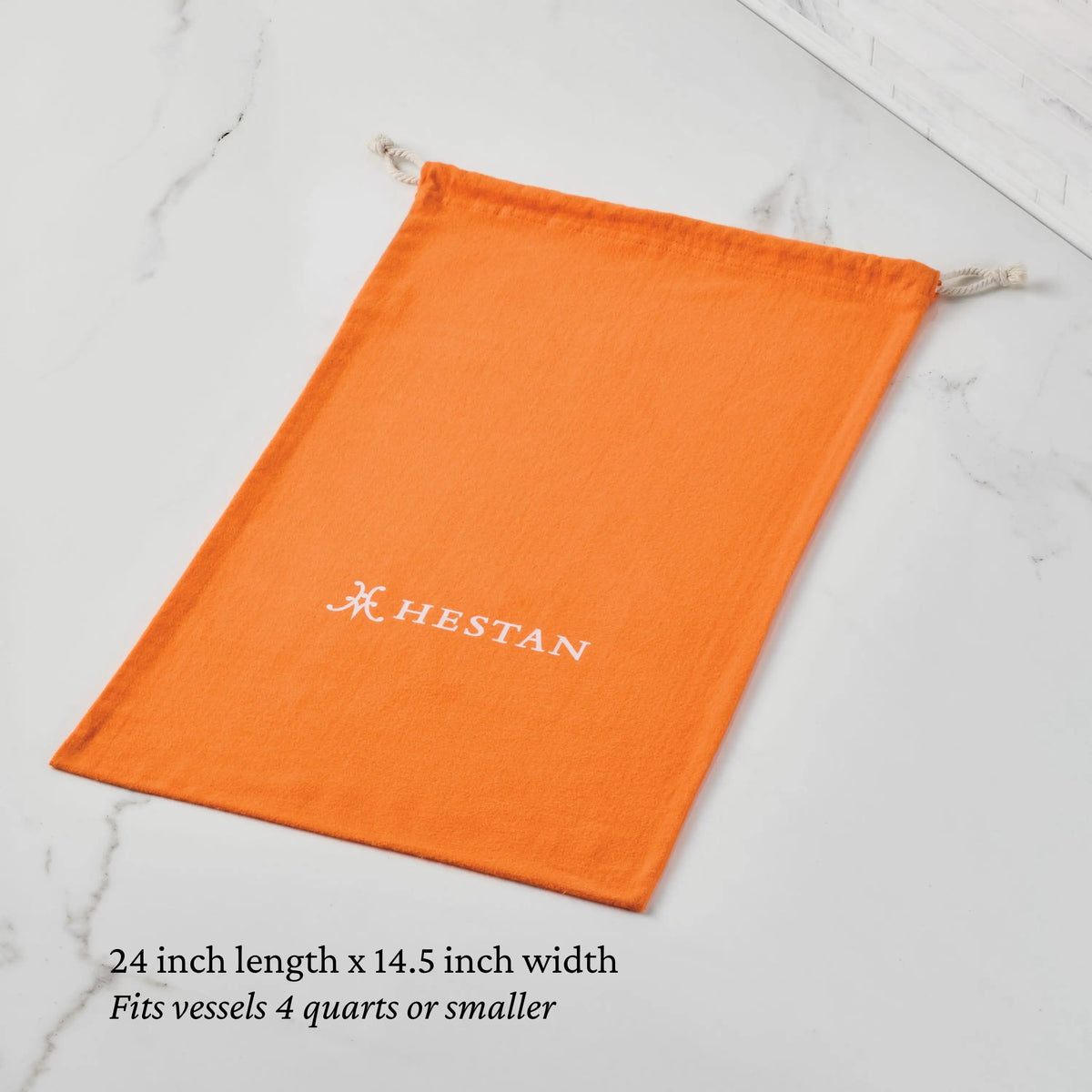 An orange Flannel Cookware Storage Bag by Accessories, featuring a white logo, rests on a marble surface. Measuring 24"x14.5", it&