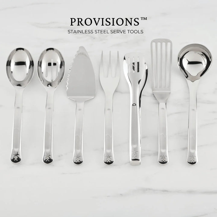 A Hestan Provisions 10.5-inch Stainless Steel Slotted Serving Spoon is one of the essential chef’s tools featured in the set, elegantly arranged on a marble surface with other serving utensils.