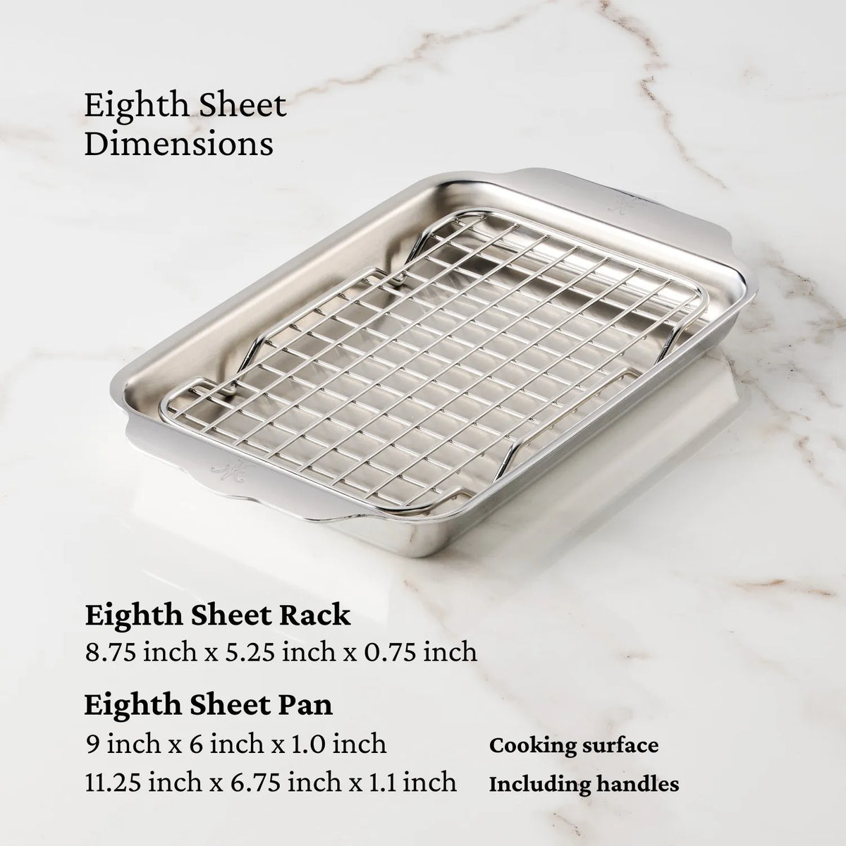 A NanoBond Titanium x Tyler Florence 41-Piece Cookware Set eighth sheet pan with fitted rack rests on marble. Text shows the pan and rack dimensions, noting differences between cooking surface and total size with handles.