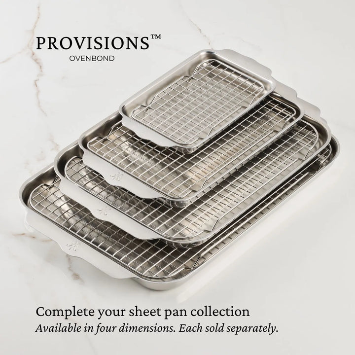 A set of four stainless steel, oven-safe nested sheet pans with cooling racks is displayed on light marble. The image includes the text Hestan Provisions OvenBond and Complete your collection. Available in four sizes, including the Tri-ply Mini Eighth Sheet Pan. Each sold separately.