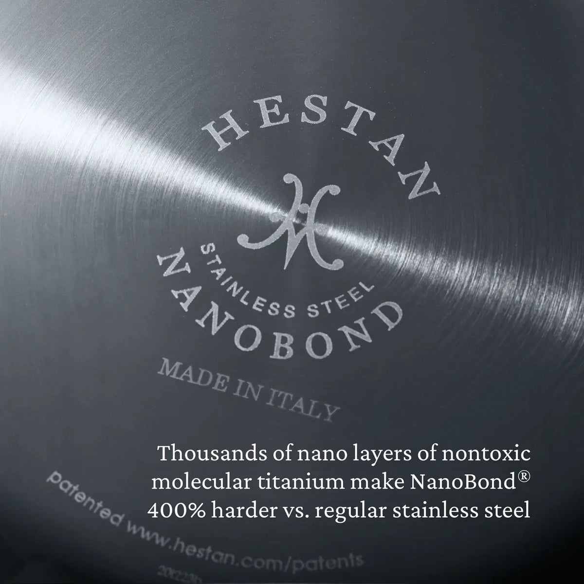 Close-up image of the bottom of a NanoBond Titanium Sauté Pan: crafted with non-toxic molecular titanium, its 400% harder than standard stainless steel. Made in Italy proudly stands out.