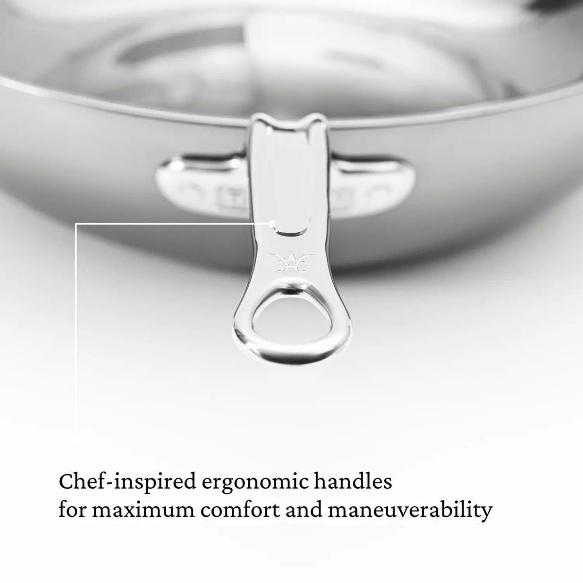 A close-up of the Titanium Chefs Pan, 14-Inch by NanoBond shows its chef-inspired ergonomic handle enhanced with Hestan NanoBond technology for optimal comfort and maneuverability, combining modern elegance and practical functionality.