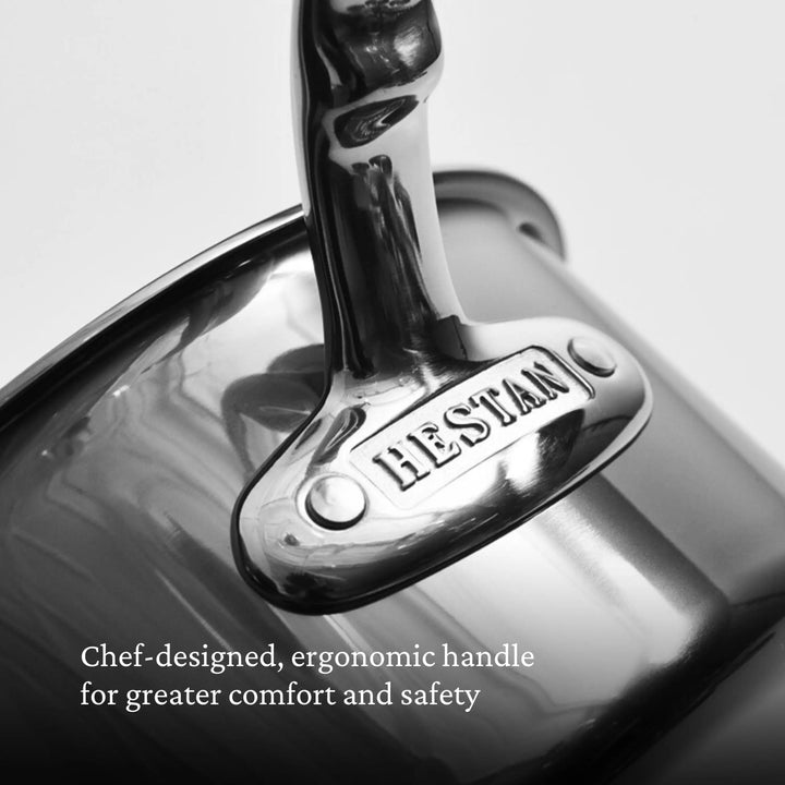 Close-up of a stainless steel pot handle with NanoBond engraved on it. Text reads: Chef-designed, ergonomic handle for comfort and safety—featured on the NanoBond Titanium Stockpots.
