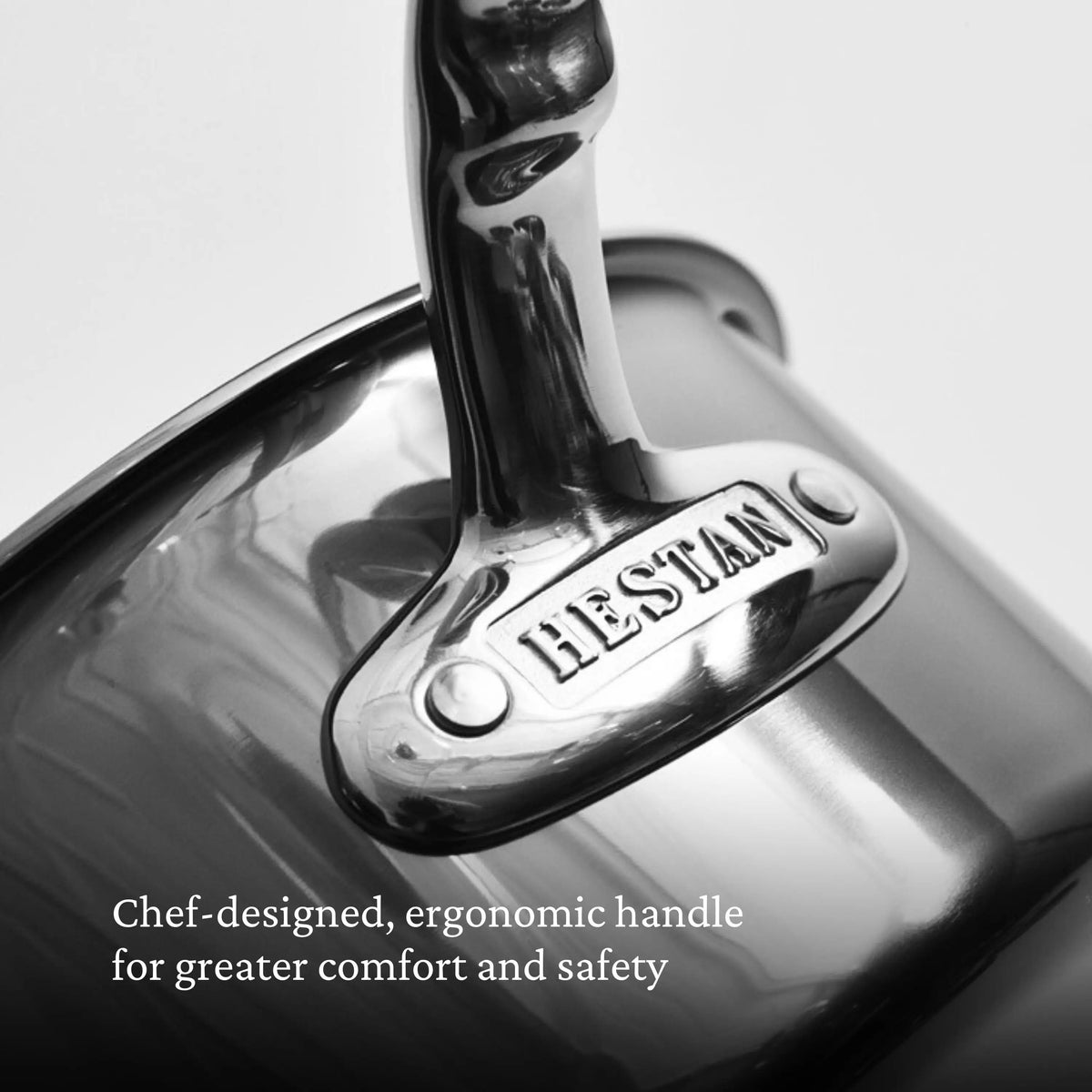 Close-up of a stainless steel pot handle with NanoBond engraved on it. Text reads: Chef-designed, ergonomic handle for comfort and safety—featured on the NanoBond Titanium Stockpots.