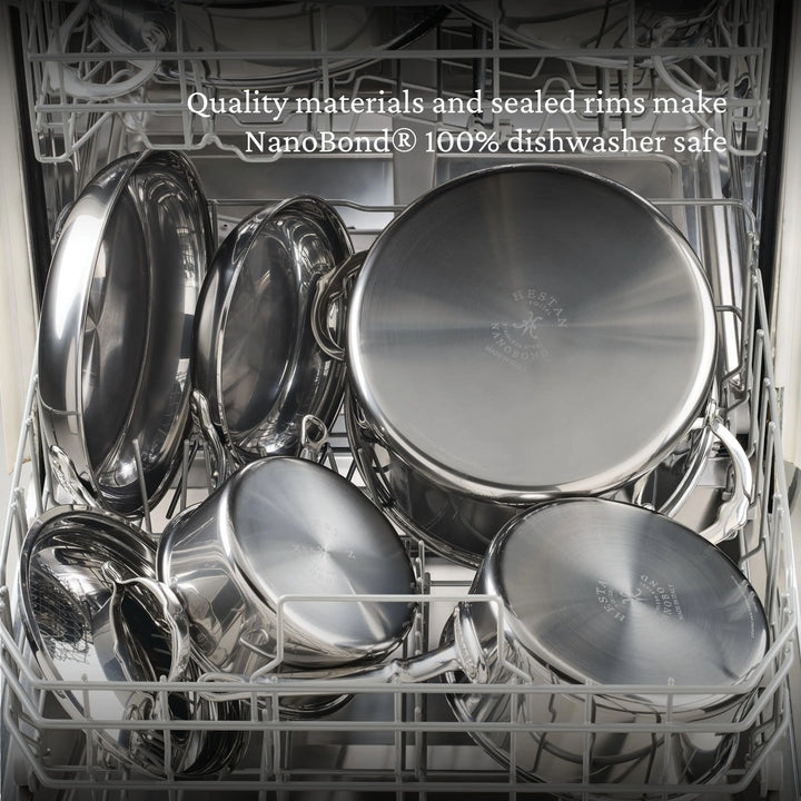An open dishwasher with clean, shiny NanoBond Titanium Stockpots and pans. Text at the top says: Premium materials and sealed rims make NanoBond® Titanium Stockpots 100% dishwasher safe.