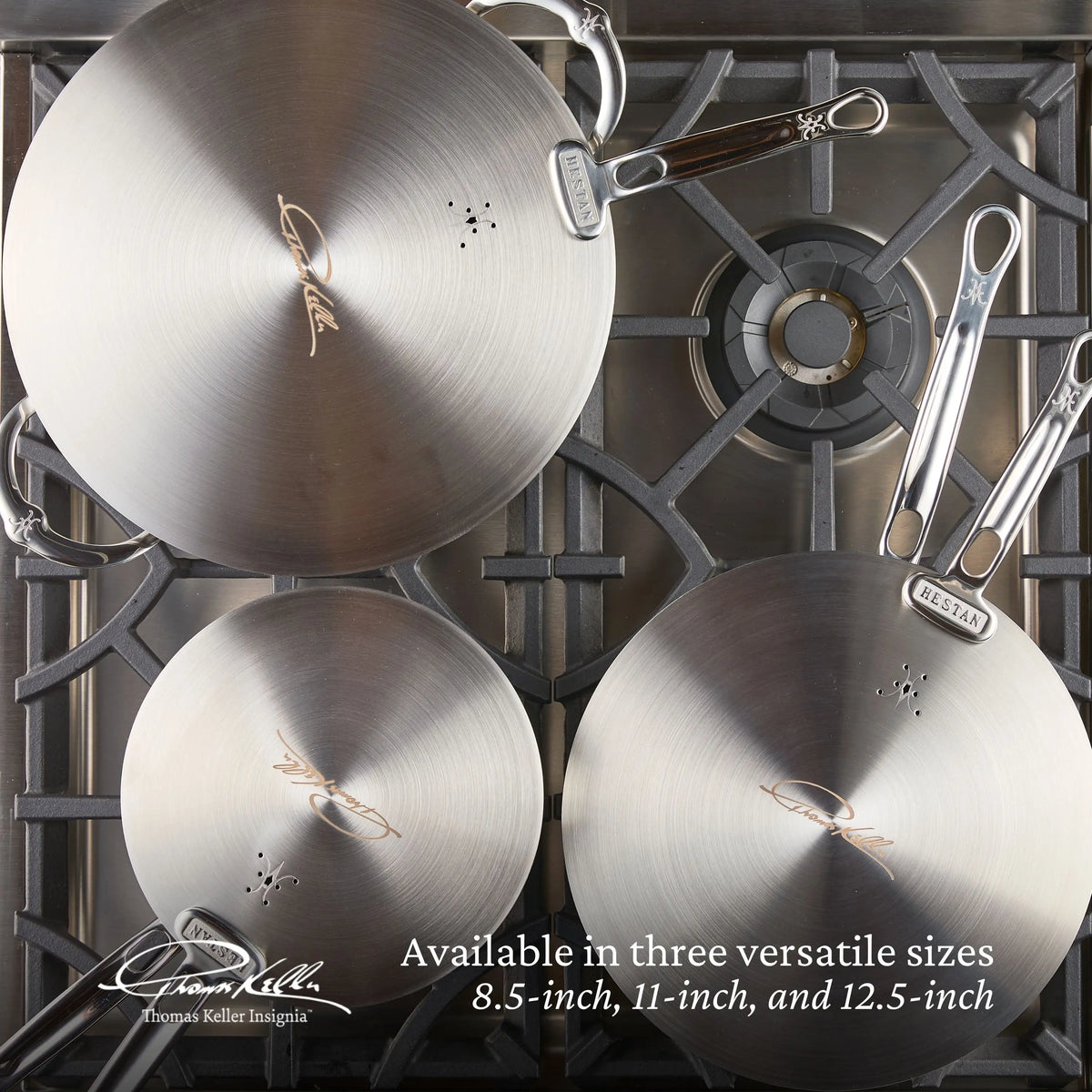Three Thomas Keller Commercial Clad frying pans (8.5", 11", and 12.5") with Stainless Steel Universal Lids sit on a gas stove, highlighting the versatility and eco-friendly design of this premium cookware when viewed from above.