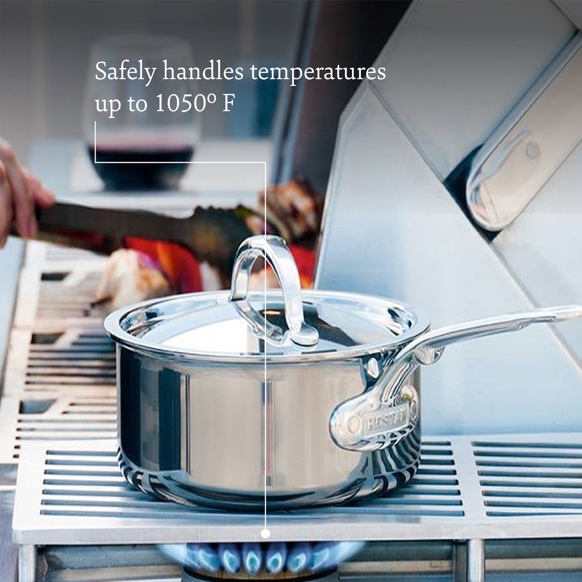 A NanoBond Titanium Induction saucepan with a lid sits on a grill, while a hand with tongs is in the background. Text reads, Safely handles temps up to 1050°F.
