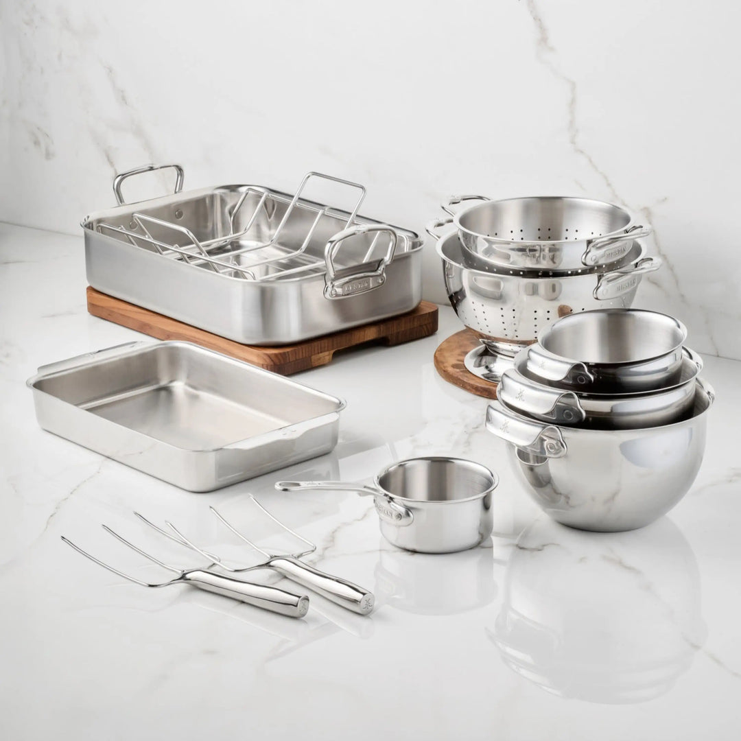 Hestan Provisions® Host and Roast, 10-piece durable stainless steel bakeware set including a roasting pan with rack, baking pan, colanders, mixing bowls, small saucepan, and two carving forks for holiday prep.