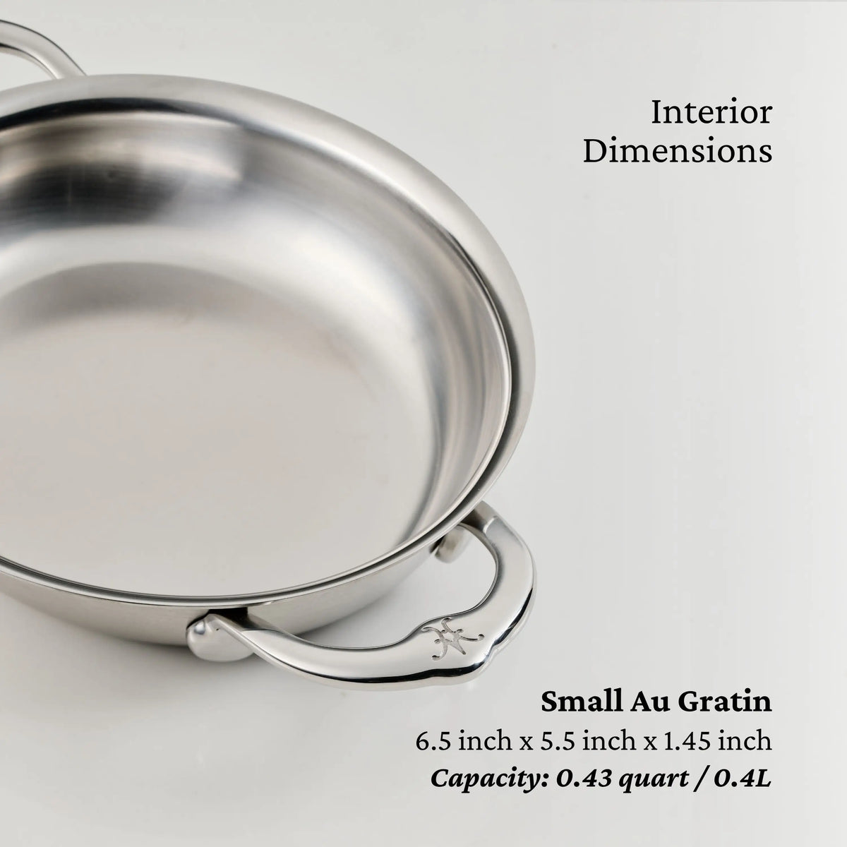 The Thomas Keller Commercial Clad Stainless Steel Small Au Gratin, part of the 29-Piece Cookware Set, features a handle and has interior dimensions of 6.5 x 5.5 x 1.45 inches with a capacity of 0.43 quart (0.4 liters).