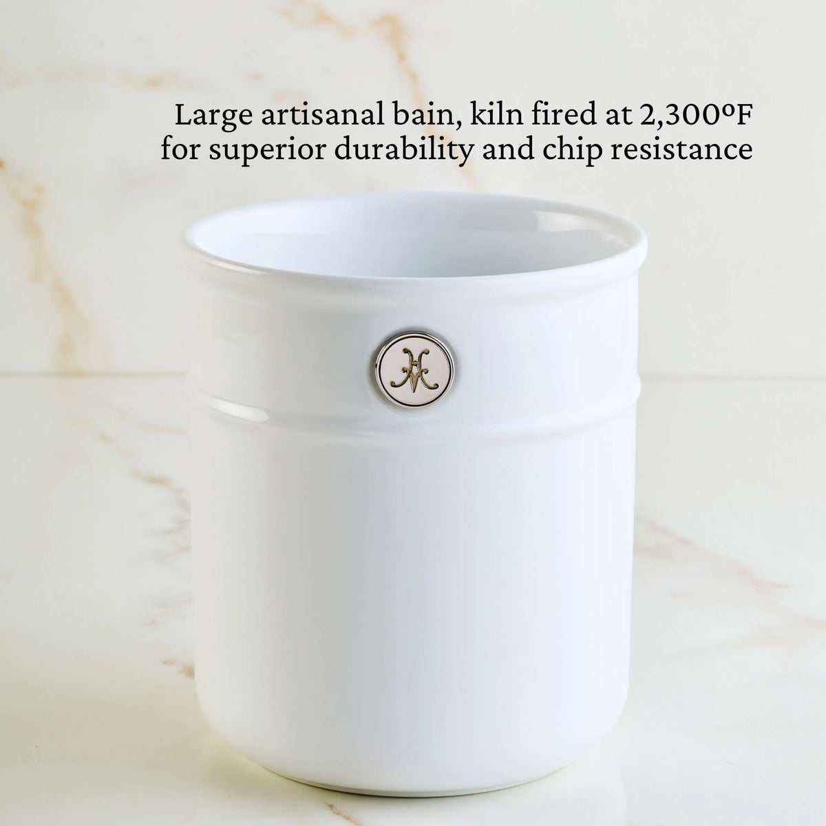 A Thomas Keller Commercial Clad Stainless Steel 29-Piece Cookware Set is shown on a marble surface. The text above highlights its large, durable design—crafted to commercial standards for lasting performance.