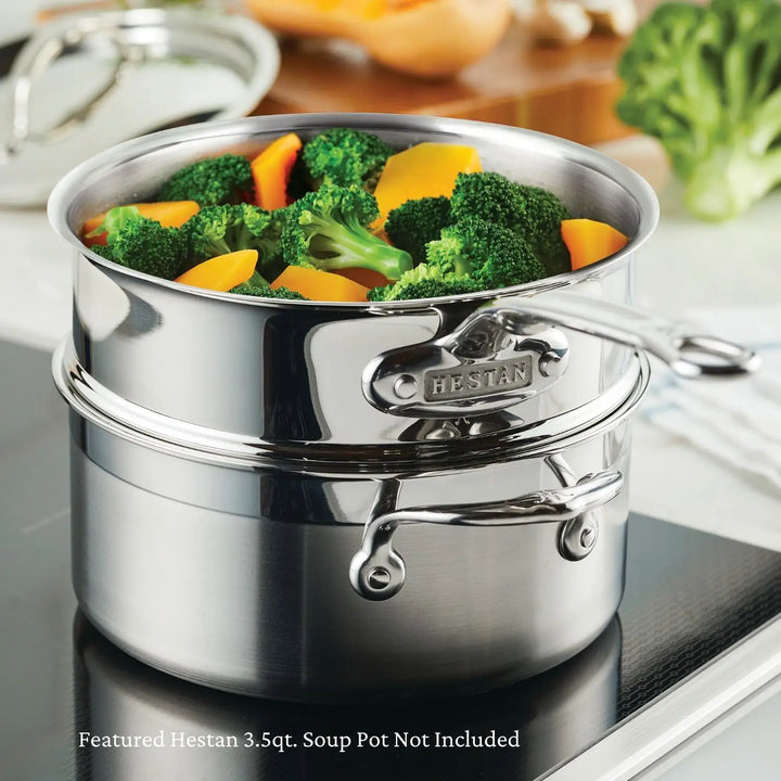 A ProBond Professional Clad Performance double boiler sits on the stovetop, its tri-ply aluminum core ensuring even heat distribution. Broccoli and carrots are in the upper pot, while various vegetables rest on the kitchen countertop, showcasing the ProBond logo proudly.