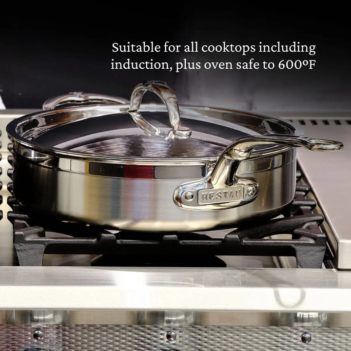 The ProBond Professional Clad Performance saucepan, part of the 28-piece set, features a tri-ply aluminum core and glass lid. With side handles engraved HESTAN, its compatible with all cooktops, including induction, and is oven safe up to 600°F.