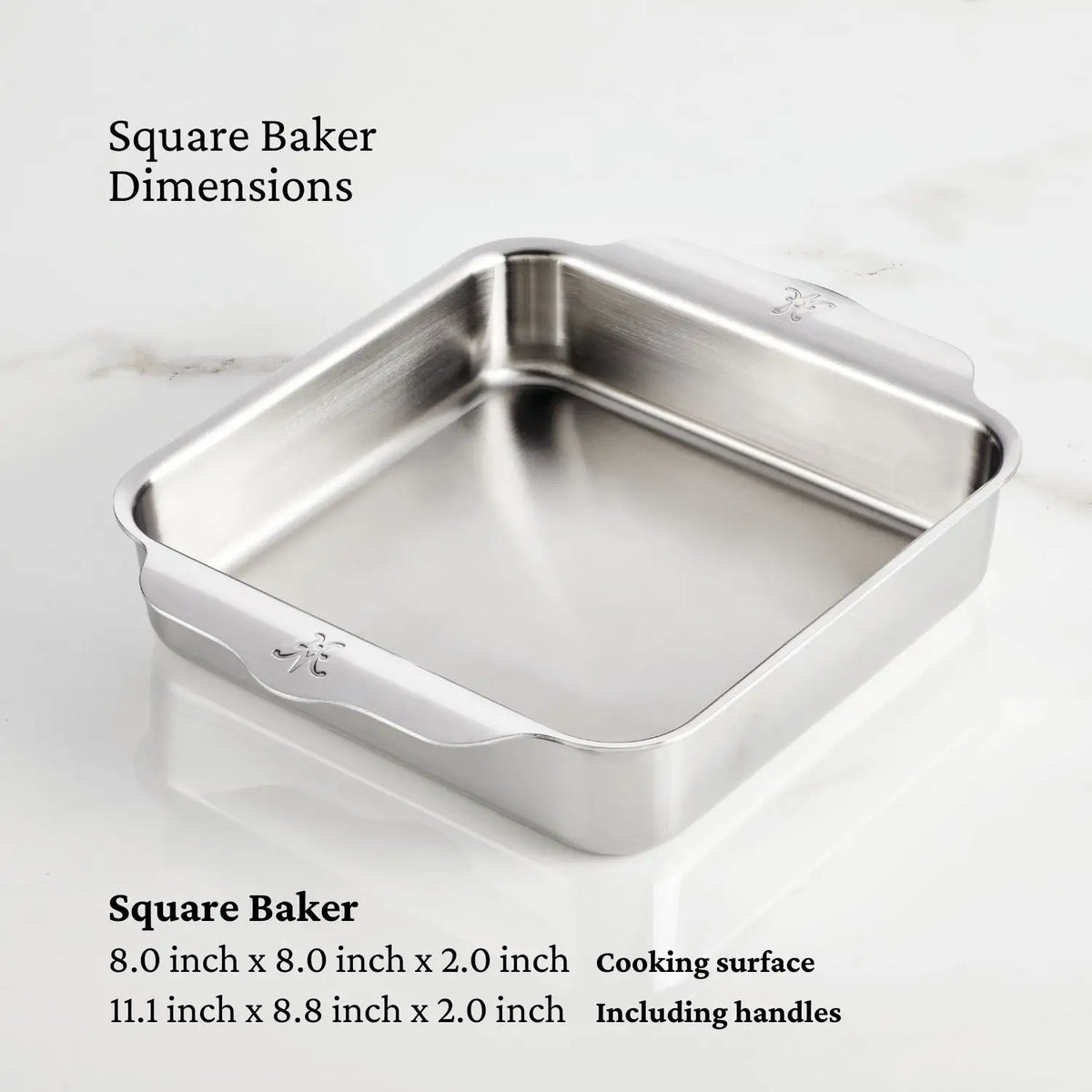A square NanoBond Titanium x Tyler Florence Cookware Set baking pan with handles rests on a white surface. Dimensions: 8.0 x 8.0 x 2.0 in cooking area, 11.1 x 8.8 x 2.0 in including handles; set includes 41 pieces.
