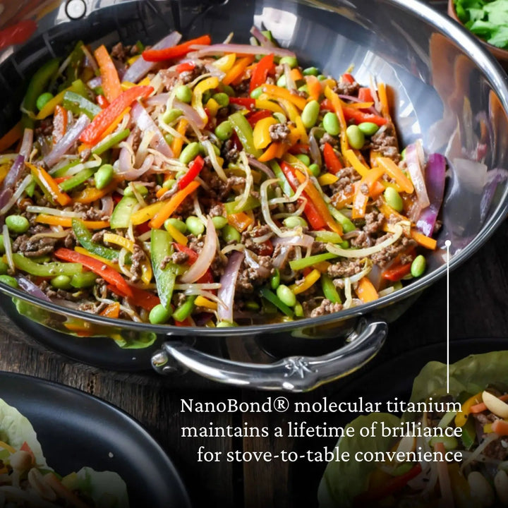 A vibrant stir-fry with vegetables and meat cooks in a shiny pan. Text reads, NanoBond® Molecular Titanium ensures lifetime brilliance for stove-to-table convenience. Nearby, the sleek 10-piece Limited Edition Winter Titanium Cookware Set complements the fresh lettuce wraps.