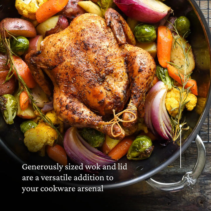 A roasted whole chicken nestles among carrots, potatoes, onions, Brussels sprouts, and cauliflower in a large wok. The text states: Part of the NanoBond 10-piece Limited Edition Winter Titanium Cookware Set, this wok is durable and versatile for your cookware needs.